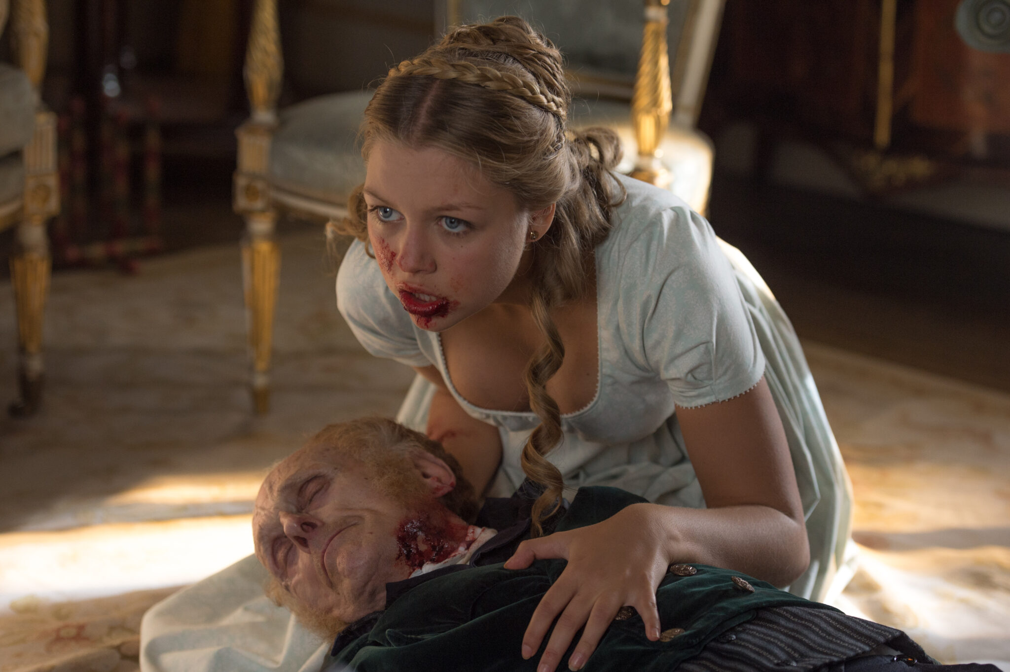 Annabelle (Jess Radomska) chewing her grandfather in Screen Gems' PRIDE AND PREJUDICE AND ZOMBIES.